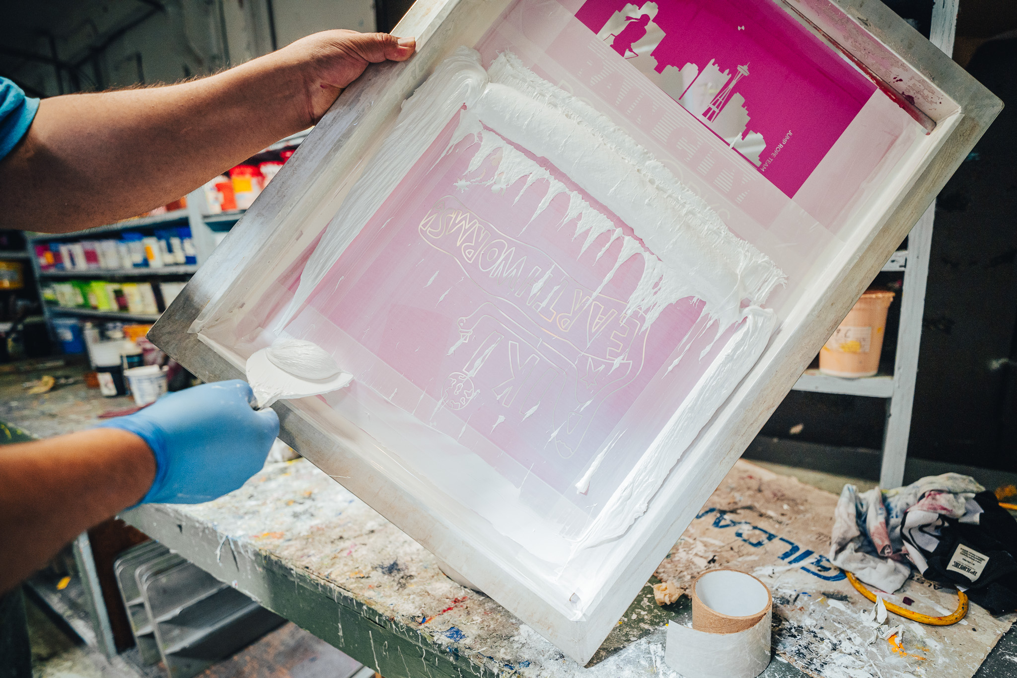 A Norwest Graphics employee preparing a screen for printing