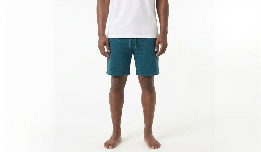 A man wearing blank blue sweatshorts